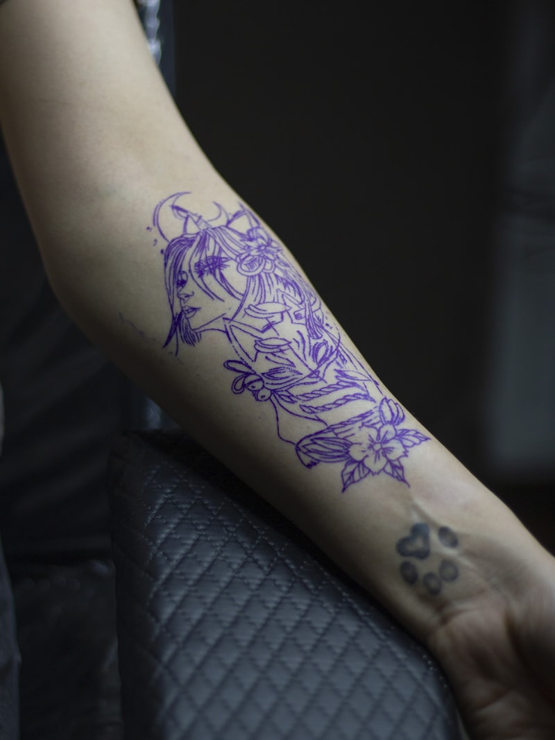 Fine-line semi-permanent tattoo design on arm