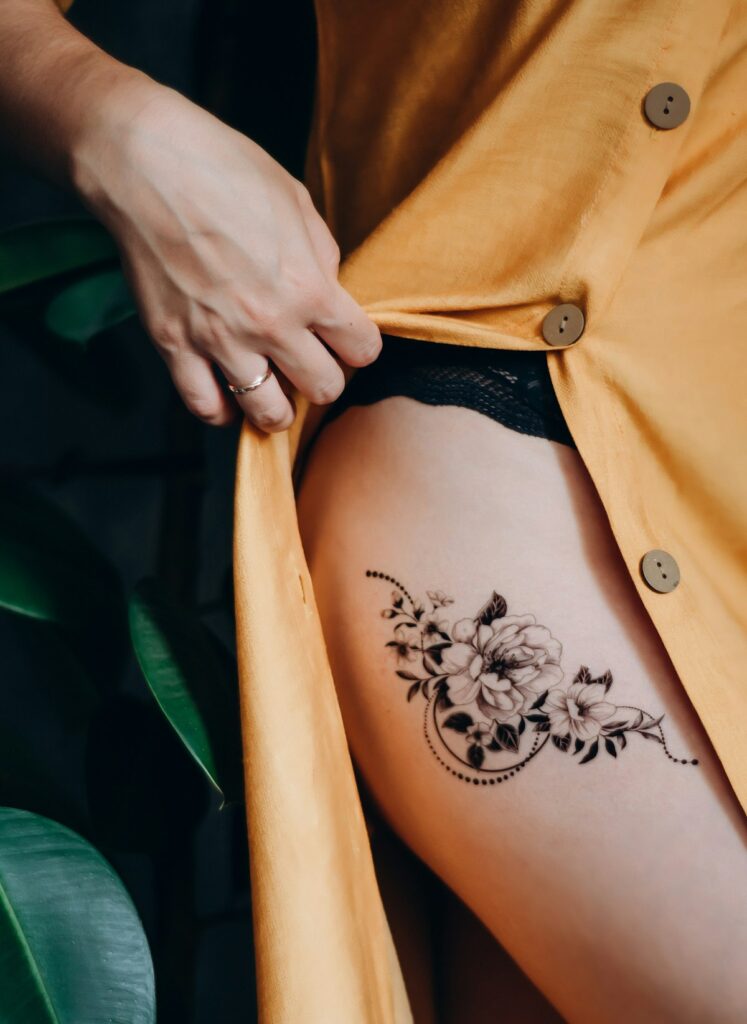 Woman with a realistic floral semi-permanent tattoo across her back