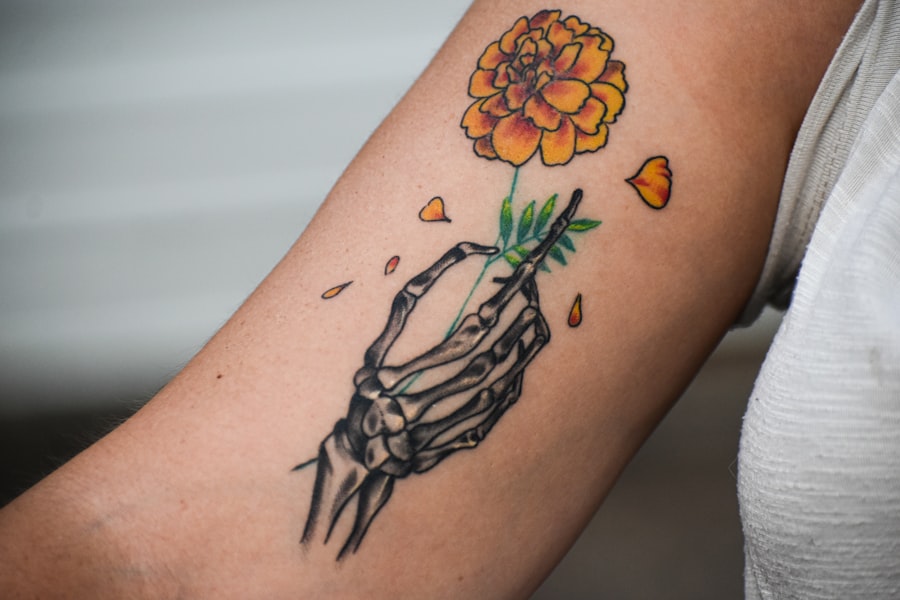 Person with a semi-permanent tattoo on their arm holding a flower