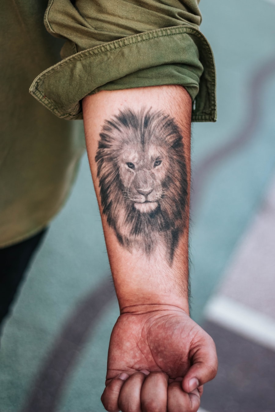 Detailed lion design semi-permanent tattoo on a forearm